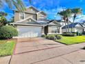 Two-story house with a white garage door and manicured lawn at 122 Stone Gable Cir, Winter Springs, FL 32708
