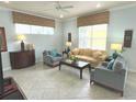 Living room with beige sofa and two armchairs at 7762 Linkside Loop, Reunion, FL 34747