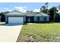 Newly built home with a two-car garage and spacious lawn at 1312 Hillsborough Ct, Poinciana, FL 34759