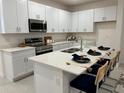 Modern kitchen with stainless steel appliances and island at 1436 Silver Lining Way, Apopka, FL 32703