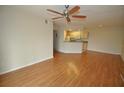 Bright living room with laminate flooring and kitchen access at 12500 Crest Springs Ln # 1032, Orlando, FL 32828