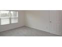 Bright bedroom with neutral walls and carpet at 11188 Hess Way, Oxford, FL 34484