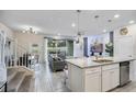 Open floor plan with island kitchen, living room, and stairs at 936 Paradise Dr, Davenport, FL 33897