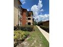 Exterior view of building with walkway and landscaping at 5578 Metrowest Blvd # 107, Orlando, FL 32811