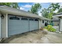 Grey garage with screen door and spacious driveway at 701 Castlewood Dr, Winter Springs, FL 32708