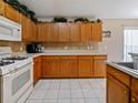 Bright kitchen featuring wood cabinets and tile flooring at 226 Jessamine Dr, Davenport, FL 33837