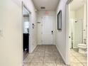 Bright entry hall with tile flooring, access to bathroom and other rooms at 4791 Terrasonesta Dr, Davenport, FL 33837