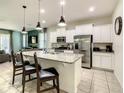 Modern kitchen featuring stainless steel appliances and granite countertops at 4791 Terrasonesta Dr, Davenport, FL 33837