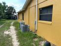 Back of house showing AC units and a pathway at 709 N Disston, Tavares, FL 32778
