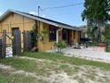Side view of house with patio and fenced yard at 709 N Disston, Tavares, FL 32778