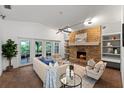 Cozy living room features a brick fireplace, built-in shelving and a view of the backyard at 8673 Vista Point Cv, Orlando, FL 32836