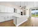 Modern kitchen with white cabinets, quartz countertops, and large island at 815 Liliana Dr, Deland, FL 32724