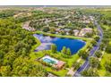Aerial view of a community with a lake and pool at 316 Shelbourne Loop, Kissimmee, FL 34759