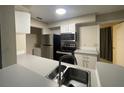 Modern kitchen with stainless steel appliances and gray counters at 1073 S Hiawassee Rd # 1018, Orlando, FL 32835
