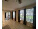 Living room with sliding door to patio and large windows at 1073 S Hiawassee Rd # 1018, Orlando, FL 32835