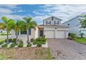 Two-story house with a two-car garage, landscaping, and palm trees at 1839 Good Neighbor Loop, Kissimmee, FL 34744