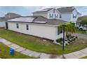 Rear view of a two-story house with solar panels and landscaping at 1839 Good Neighbor Loop, Kissimmee, FL 34744