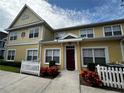 Front view of charming townhome with white picket fence at 4000 Santa Maria Dr # 105, Kissimmee, FL 34741