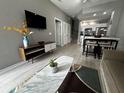 Open living room with modern decor and kitchen view at 4000 Santa Maria Dr # 105, Kissimmee, FL 34741