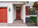 Red front door with brick walkway at 5431 Solterra Cir, Davenport, FL 33837