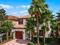 Two-story house with red door and palm trees at 5431 Solterra Cir, Davenport, FL 33837
