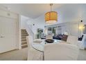 Bright dining area with a round glass table and white chairs, near the kitchen at 11886 Nautica Dr, Orlando, FL 32827