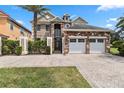 Two-story house with stone and stucco exterior, three-car garage, and landscaping at 1257 Radiant St, Reunion, FL 34747