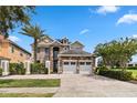 Two-story house with stone and stucco exterior, three-car garage, and landscaping at 1257 Radiant St, Reunion, FL 34747