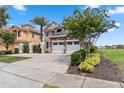 Two-story house with stone and stucco exterior, three-car garage, and landscaping at 1257 Radiant St, Reunion, FL 34747