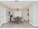 Dining room with modern chandelier and seating for six at 213 E Hillcrest St, Altamonte Springs, FL 32701