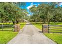 Long driveway leading to house with brick pillars at 12151 Walker Pond Rd, Winter Garden, FL 34787
