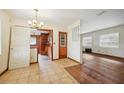 Dining room with tiled floor, wood-paneled walls, and access to kitchen at 3034 Touraine Ave, Orlando, FL 32812