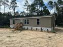 Single-wide manufactured home with landscaped front yard at 17697 Sw 40Th St, Dunnellon, FL 34432