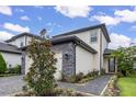 Two-story house with stone accents and a two-car garage at 1409 Bellamy Dr, Reunion, FL 34747