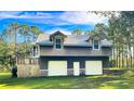 Two-car garage with extra storage space and a large deck at 2620 Osceola Bluff Ln, Geneva, FL 32732