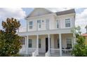 Two-story house with white columns and balcony at 7410 Barrier Cove Way, Kissimmee, FL 34747