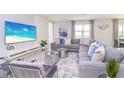 Spacious living room featuring a large sectional sofa, stylish coffee tables, and a large TV at 4498 Monado Dr, Kissimmee, FL 34746