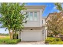 Modern home with stone accents and two-car garage at 837 Desert Mountain Ct, Reunion, FL 34747