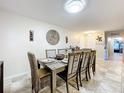Spacious dining room with a large wooden table and six chairs at 100 E Oak Terrace Dr # G1, Leesburg, FL 34748