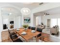 Bright dining room with a wood table and modern chandelier at 4901 Culdesac Ct, Saint Cloud, FL 34772