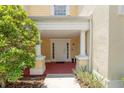 Inviting front entry with columns and a well-lit walkway at 7509 Seven Eagles Way, Reunion, FL 34747