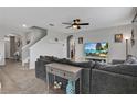 Spacious living room with sectional sofa and large TV at 209 Sofia Ln, Lake Alfred, FL 33850