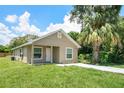 Tan house with a small front yard and driveway at 2228 Sipes Ave, Sanford, FL 32771