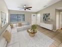 Bright living room with a sectional sofa and a large window at 110 Lindenwood Ln, Kissimmee, FL 34743