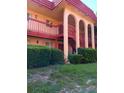 Two-story condo building with red tile roof and arched entryways at 2860 N Powers Dr # 133, Orlando, FL 32818