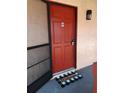 Red condo entrance with welcome mat and security system at 2860 N Powers Dr # 133, Orlando, FL 32818
