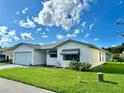 White single story home with a two car garage and landscaped lawn at 4901 Pleasant Hollow Trl, Lakeland, FL 33811