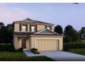 Two-story house with a beige exterior and a two-car garage at 1701 Andover Ridge Dr, Deland, FL 32720