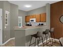 Kitchen features breakfast bar and modern appliances at 1121 Park Ridge Cir, Kissimmee, FL 34746