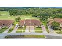 Tan two-story home with double garage and manicured lawn near golf course at 26841 Bella Vista Dr, Howey In The Hills, FL 34737